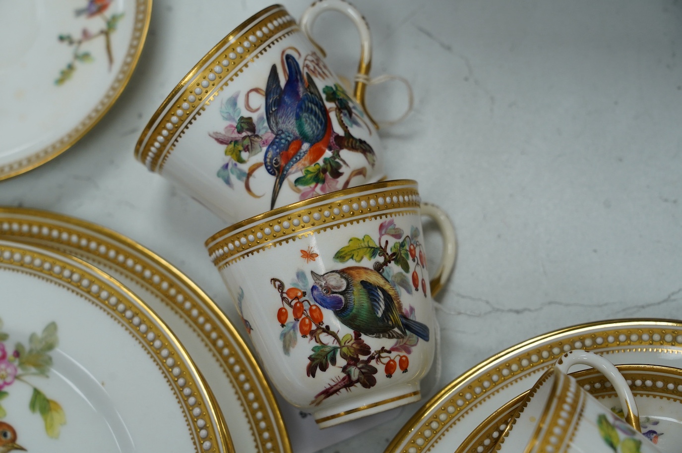 A 19th century Royal Worcester ornithologically decorated part tea set, with gilt and jewelled edges, six place setting. Condition - good